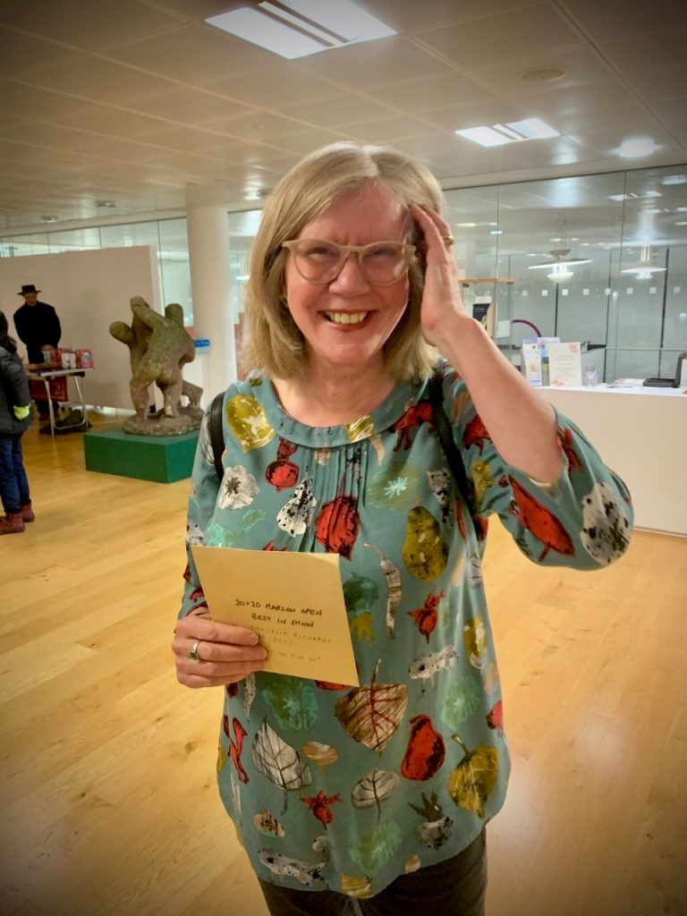 Chrissie with her golden envelope for winning Harlow 2020 Open exhibition