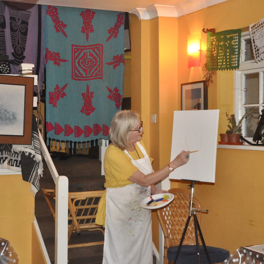 Chrissie Richards artist demonstrating painting at a paint night in Mexican restaurant in Sawbridgeworth