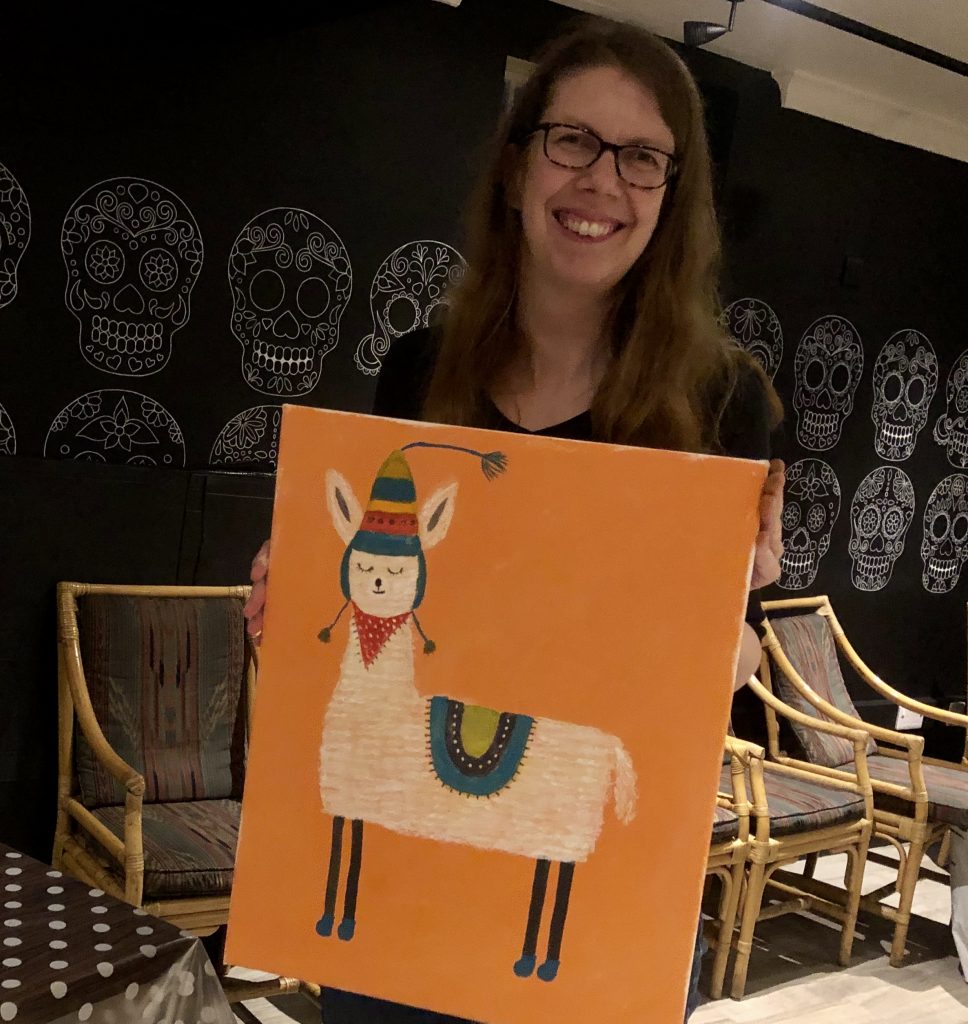 lady smiling showing llama painting at paint night with Chrissie Richards