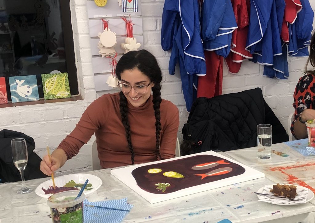 lady smiling doing still life panting at paint night with Chrissie Richards