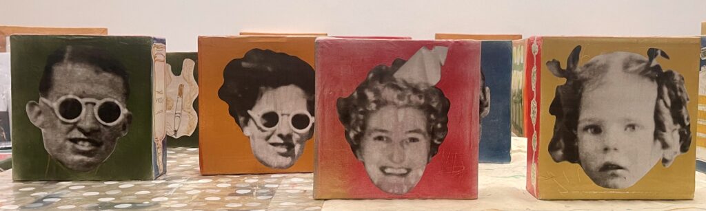 cardboard boxes with photographs of vintage faces on them